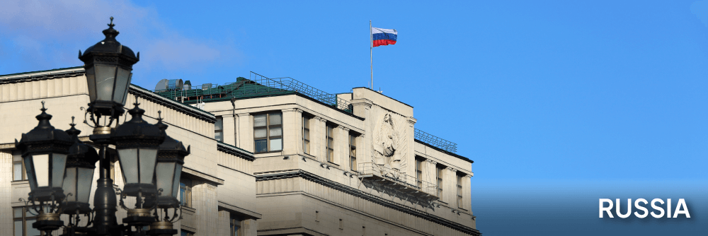 a view of the Council of Labor and Defense building in Russia behind a lampost